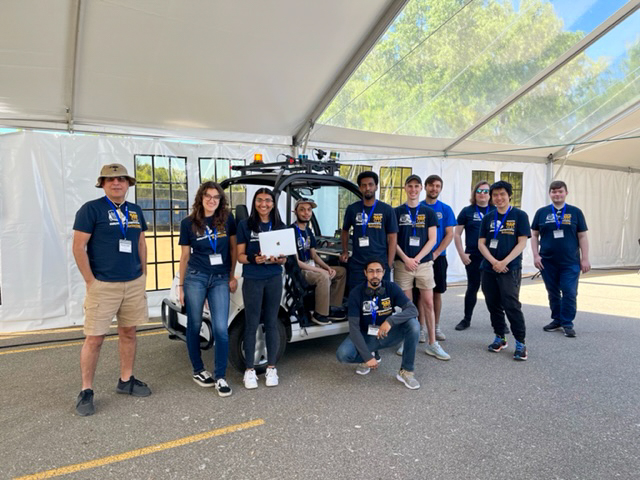 Members of the ϲʷ¼ Intelligent Ground Vehicle Competition Team pose in front of their cart.