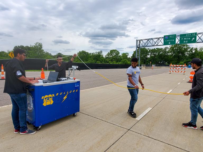 Members of the ϲʷ¼ AutoDrive team work with their cart during competition.