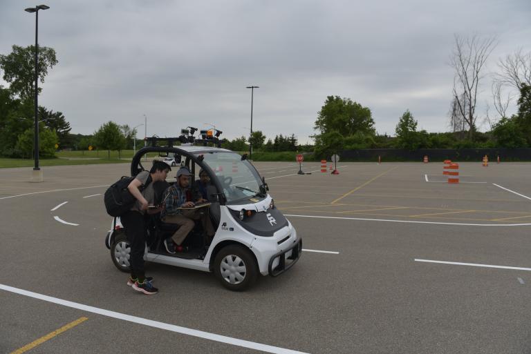 Members of the ϲʷ¼ IGVC team drive the golf cart during competition.